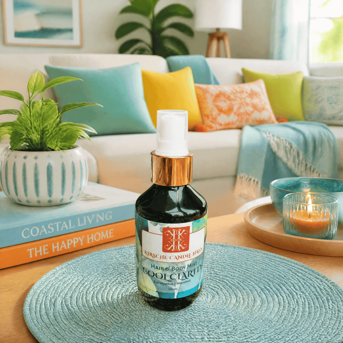 A bottle of Kirsche Candle Haus Handmade in Wellington NZ Cool Clarity Hair & Body Mist placed on an aqua blue coloured placemats in a bright living room with beige sofa and colourful cushions in the image background.